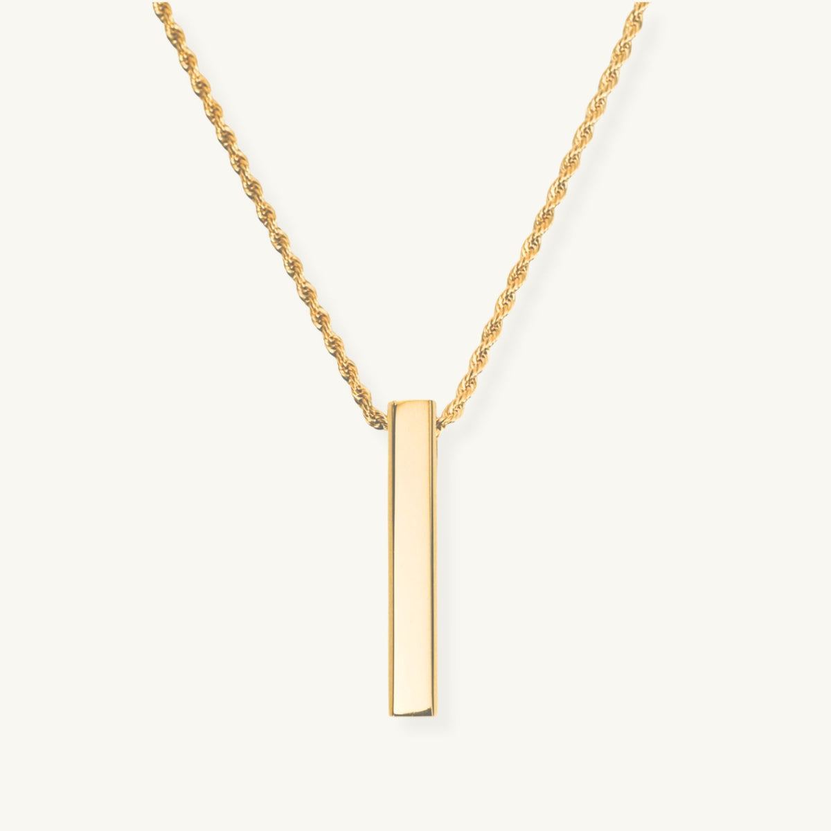 Gold necklace with a vertical bar pendant on a white background