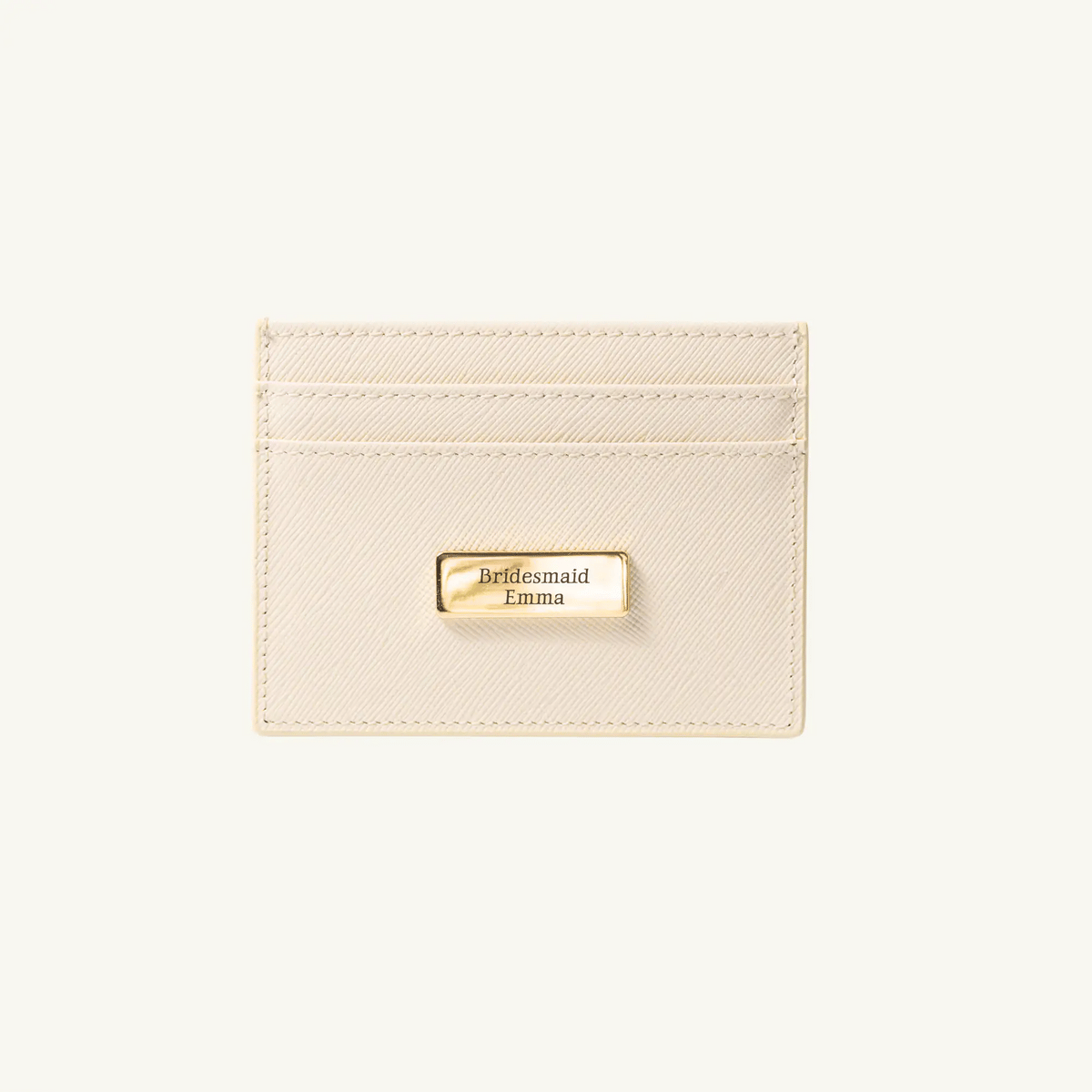 Beige cardholder with gold tag on a white background